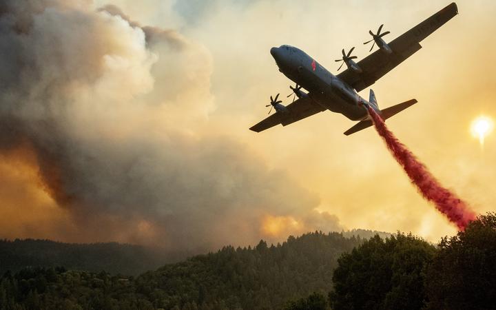 An aircraft drops fire retardant on a ridge during the Walbridge fire, part of the larger LNU Lightning Complex fire as flames continue to spread in Healdsburg, California on August 20, 2020. 