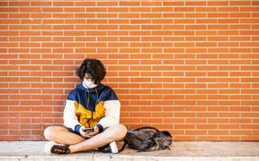 Perpignan, June 10, 2020, Classes resume at the Lycée Arago in Perpignan. History class with wearing of the mask for the teacher and the students. High school student waiting between two classes on his mobile phone and wearing the mask.