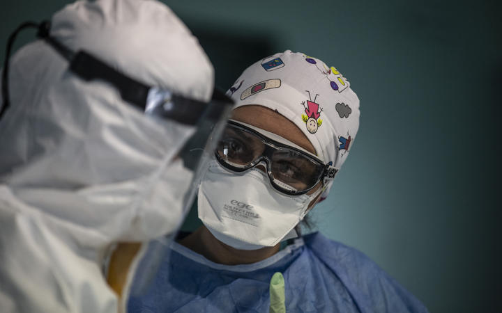 Doctors with protective glasses, protective suits and masks before applying a treatment for a coronavirus patient at Istanbul University Medical Faculty Hospital in Istanbul, Turkey 