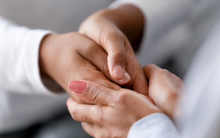 Close up caring African American mother holding child hands, showing love and support, black mum comforting, caressing kid, children protection concept, family enjoying moment together