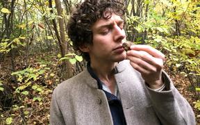 Merlin Sheldrake smelling a white truffle (tuber magnatum) in a wood in Italy