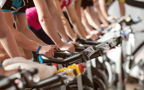 gym detail shot - people cycling; spinning class