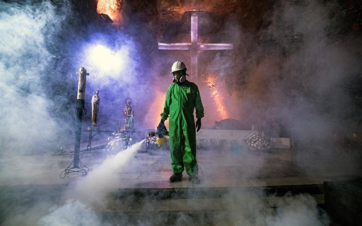 A worker disinfects the Salt Cathedral of Zipaquira, an underground church built into a salt mine, in Colombia on August 30, 2020. 