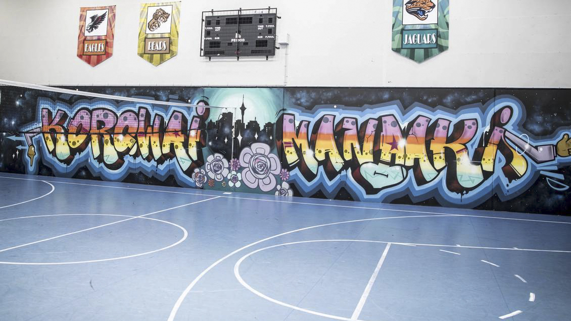 A youth centre with basketball court and graffiti mural