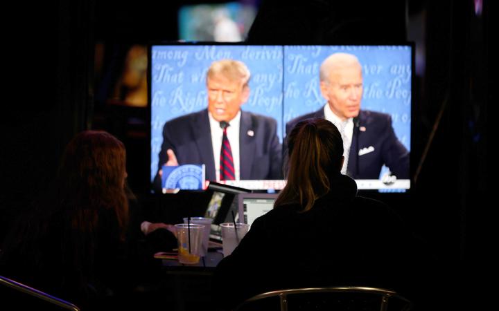 People watch the first presidential debate between US President Donald Trump and former US Vice President Joe Biden.