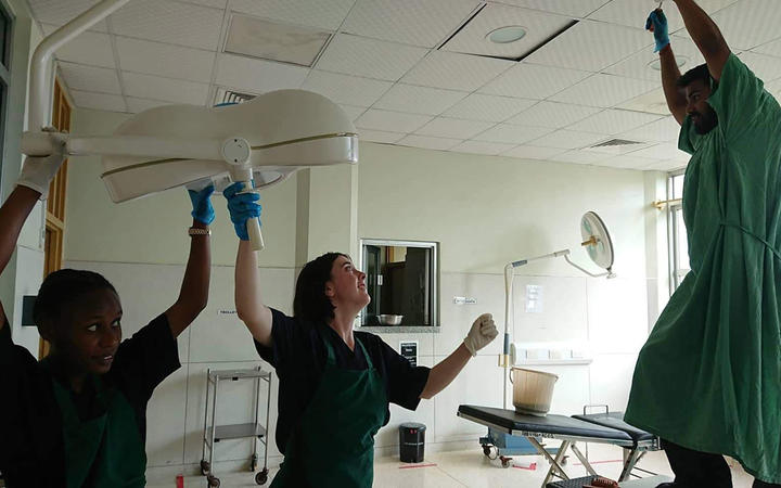 Kiara Miller and fellow interns, triumphant after fixing surgical lights, at Entebbe Hospital, Uganda