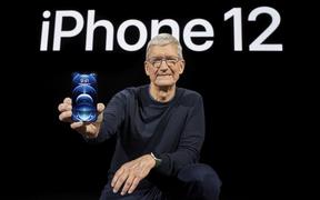 In this photo released by Apple, Apple CEO Tim Cook holds up the all-new iPhone 12 Pro.