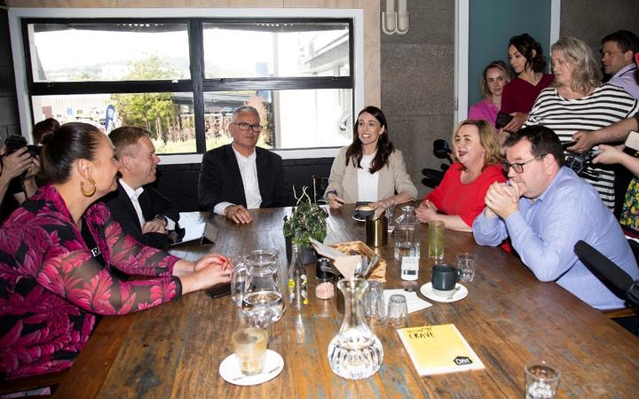 New Zealand Prime Minister Jacinda Ardern (centre R) speaks with senior members of parliament a day after her landslide election win.