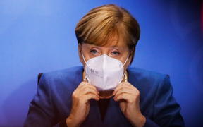28 October 2020, Berlin: Chancellor Angela Merkel puts on her face mask at the end of a press conference in the Chancellery after a meeting with the prime ministers of the Länder on how to proceed in the corona pandemic.