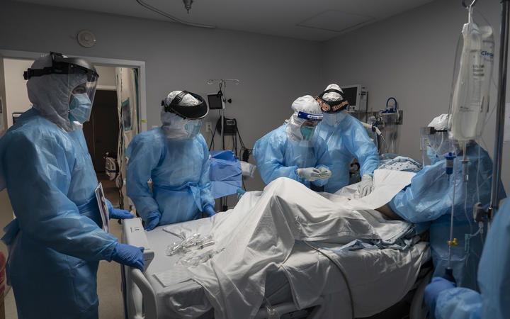 Medical staff members treat a patient suffering from Covid-19 in an intensive care unit at the United Memorial Medical Center on October 31, 2020 in Houston, Texas. 