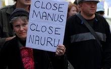 Street marcher with sign calling for closure of Nauru and Manus island detention center during World Refugee Rally June 20, 2015 in Brisbane, Australia.