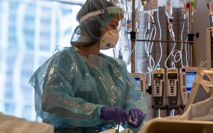 This image released by Northwestern Medicine, shows nurses at the Covid-19 Intensive Care Unit of Northwestern Memorial Hospital in Chicago.