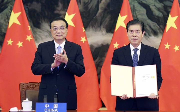 Chinese Premier Li Keqiang attends the signing ceremony of the RCEP agreement along with Commerce Minister Zhong Shan, who signed on behalf of China.