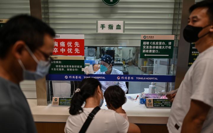 A medical worker conducts blood testing on patients in Tongji Hospitai, in Wuhan on September 3, 2020, while local authorities made a visit with media to the hospital. 