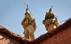 A handout photo released by Australian Department of Defence on October 21, 2009 shows Australian soldiers from the Special Operations Task Group using their rifle scopes to investigate the surrounding mountains during an operation in southern Afghanistan.  
