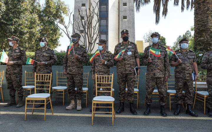 Members of the Ethiopian Army stand holding Ethiopian national flags during an event to honour the national defence forces in Addis Ababa, on November 17, 2020. 