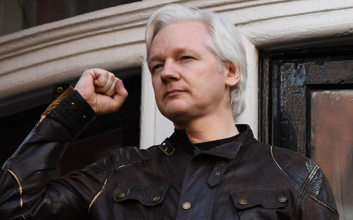 In this file photo taken on May 19, 2017 Wikileaks founder Julian Assange raises his fist prior to addressing the media on the balcony of the Embassy of Ecuador in London on May 19, 2017.