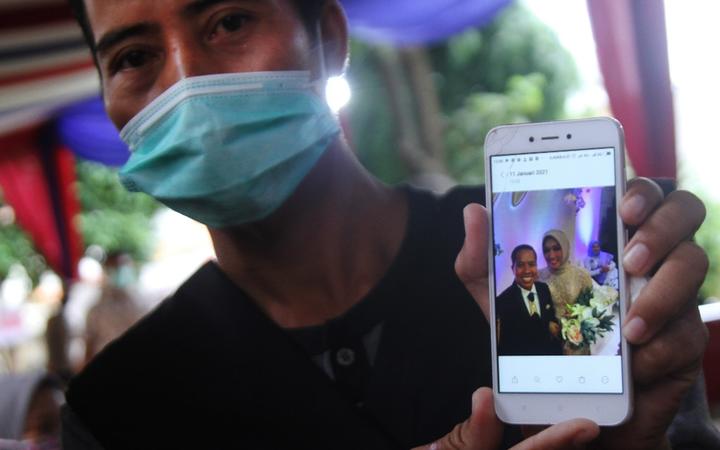 JAKARTA, INDONESIA - JANUARY 12: Slamet Bowo, the relative of the Sriwijaya Air SJ-182 plane crash shows a photo of his brother during his visit to the Police Hospital, Jakarta, Indonesia on Tuesday, January 12, 2021. 