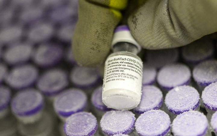 A French pharmacist holds a vial of the undiluted Pfizer-BioNTech vaccine, stored at -70 °, on 15 January, 2021.