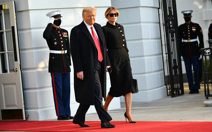 Donald Trump and First Lady Melania make their way to board Marine One, leaving the White House for the final time.