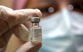 A nurse holds a vial of the Pfizer vaccine at the Pablo Arturo Suarez Hospital in Quito on January 21, 2021.