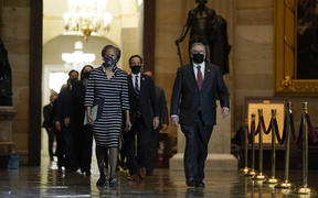 Clerk of the House Cheryl Johnson leads the Democratic House impeachment managers through Statuary Hall to deliver the article of impeachment to the Senate.