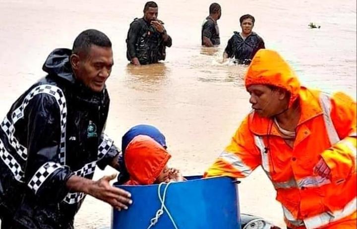 People are helped to get to safety by local police 