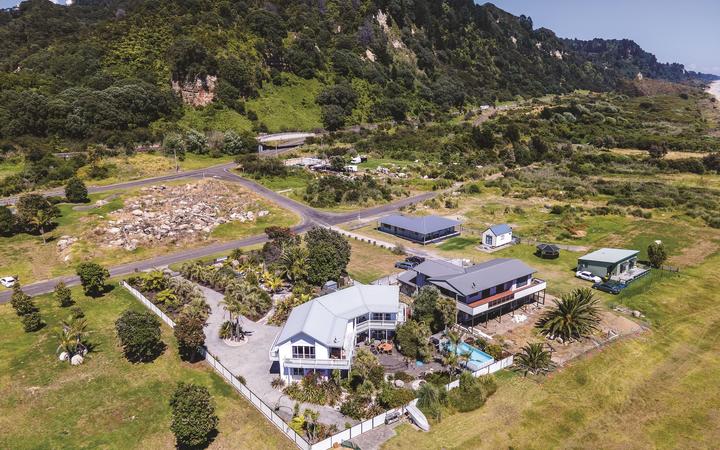 Several homes have already been removed from the Awatarariki fanhead. Rick and Rachel Whalley’s (front) will be the last to go. 