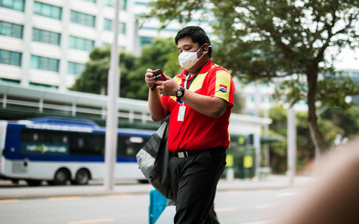 A man wears a mask during level 2 in Wellington, 15 February 20201.