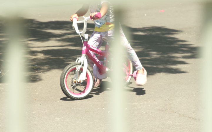 A child on a bike at an emergency accommodation motel.