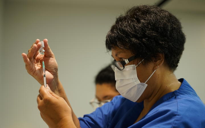 A vaccinator prepares one of New Zealand's first Covid-19 vaccinations on 19 February.