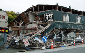 A photo taken on February 22, 2011 shows a collapsed row of shops on Worcester Street in Christchurch. 