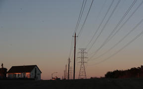 File photo. Electric power lines run through a neighborhood in Austin, Texas, 19 February. 