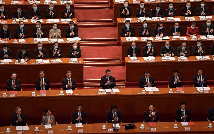 China's President Xi Jinping (centre) applauds with other leaders after the result of the vote on changes to Hong Kong's election system was announced in a session of the National Peoples Congress on Thursday.
