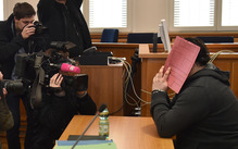 Niels H hid behind a folder during his trial last year.