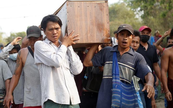 Mourners carry the coffin of Tin Hla, 43, who was shot dead by security forces during a protest against the military coup in Thanlyin township, outskirts of Yangon, Myanmar on March 27, 2021. 
