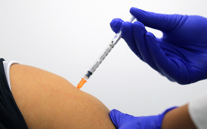 A woman receives a dose of the Pfizer/BioNTech Covid-19 vaccine during the first rollout in Australia at the Castle Hill Medical Centre in Sydney on February 21, 2021. 
