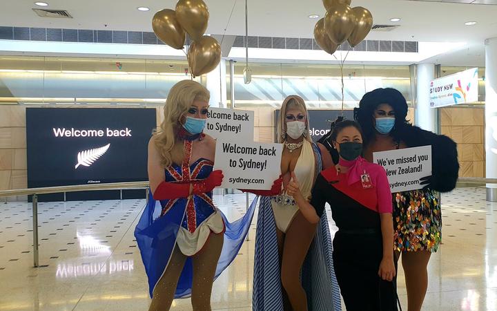 Drag queens welcome visitors to Australia on the first day of the trans-Tasman bubble