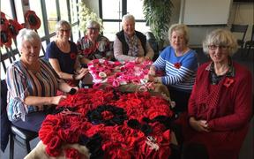 Knitters from Churton Park and Kāpiti, from left, Christine McEwan, Cheryl Brownrigg, Helen McDiarmid, Sue Grant, Pat Vincent, Caroline Smith at Kāpiti Coast Airport.
