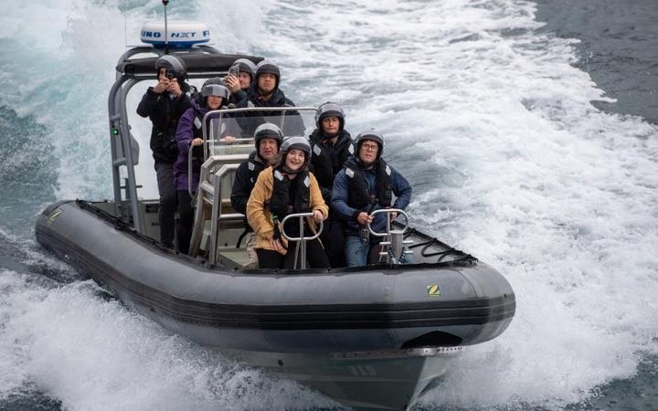 A media team on their way out to HMNZS Aotearoa. 