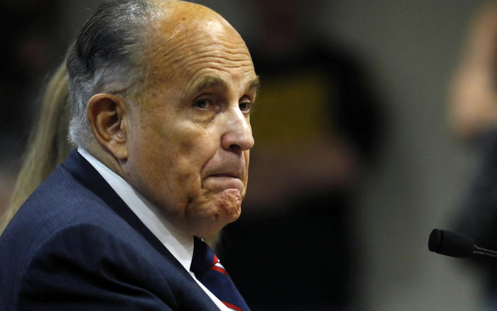(FILES) In this file photo Rudy Giuliani, former personal lawyer of US President Donald Trump, looks on during an appearance before the Michigan House Oversight Committee in Lansing, Michigan on December 2, 2020.