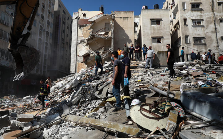 Palestinians inspect a destroyed house, after it was struck by Israeli strikes, in Gaza City this week.