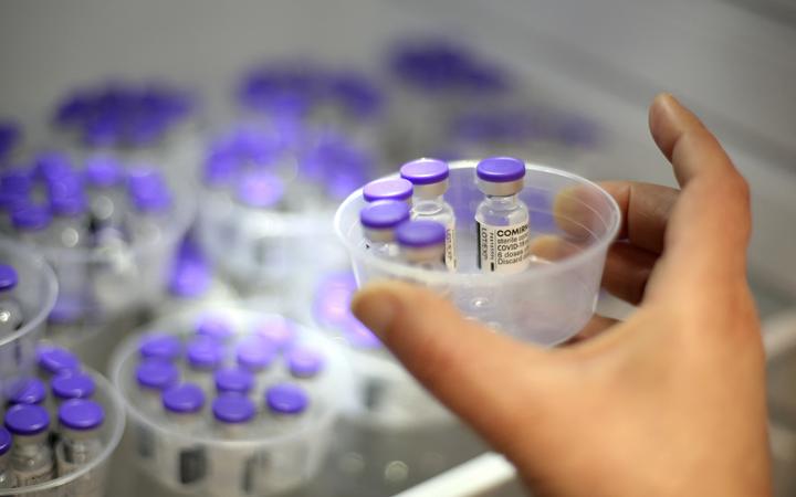 A nurse takes vials of Comirnaty vaccine by Pfizer-BioNTech against Covid-19 out of a fridge at the Baleone vaccine centre in Ajaccio on the French Mediterranean island of Corsica, on May 13, 2021. 