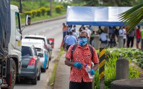 This picture taken on April 26, 2021 shows security officers checking cars along a road in Suva after the Fijian capital entered a 14-day lockdown following a Covid-19 spike following a "superspreader" funeral event.