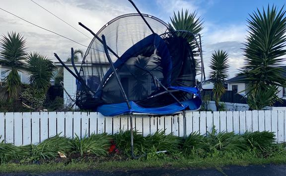 The tornado threw this trampoline on to a fence