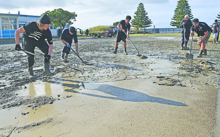 A team at work on the mud at Hatea a Rangi School, from left, Fergus Knight, Whetu Beale, Turoa Kohatu and Hauiti Kohatu.