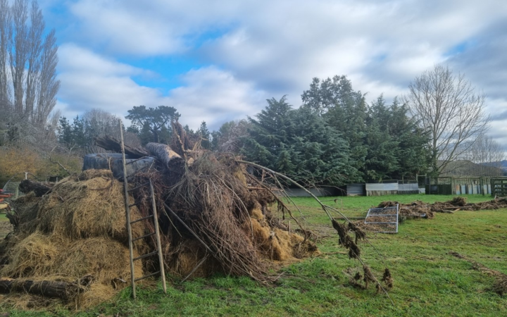 Debris left from the flooding, and a fence thrown across Gary Williams' paddock in Okuku, north Canterbury.