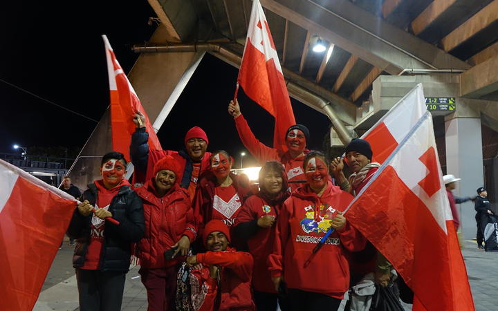 Tonga fans leave the stadium in good spirits.