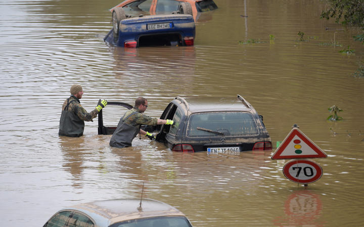 Soldiers of the German armed forces Bundeswehr search for flood victims in submerged vehicles on the federal highway B265 in Erftstadt.