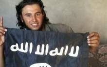 A young ISIS fighter holding a flag